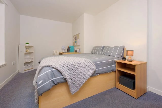Bed with desk bookshelf safe and lamp bedroom at Keiller Court in Dundee Student Accommodation