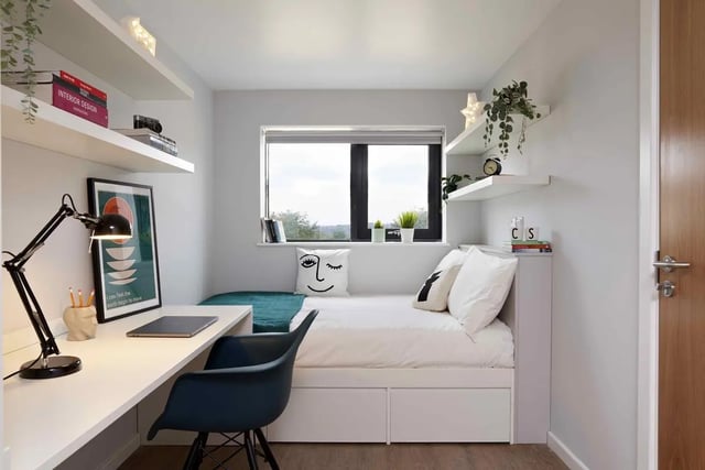 Desk bed lamp chair shelves and window bedroom at St Teresa House in Plymouth Student Accommodation
