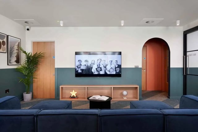 Blue sofas television plant and bookshelf common area at St Teresa House in Plymouth Student Accommodation