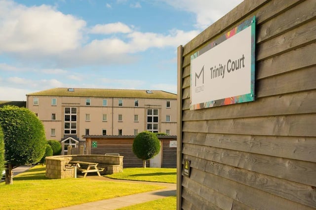 Sign and courtyard picnic table exterior at Trinity Court in Aberdeen Student Accommodation