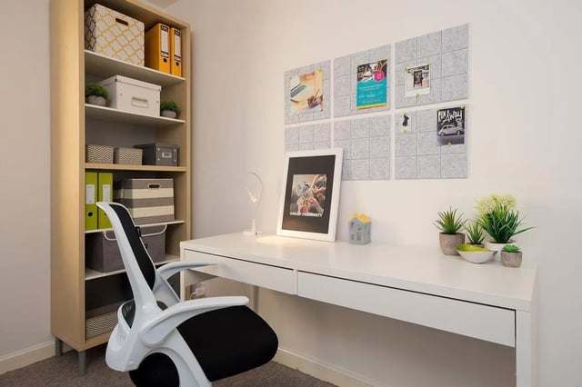 Desk with chair shelving plants and framed art study area at Trinity Court in Aberdeen Student Accommodation