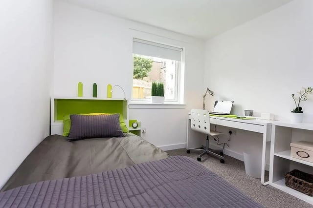 Bed desk chair laptop and storage bedroom study area at King Street 403 in Aberdeen Student Accommodation