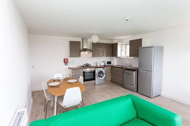 Kitchen with dining table refrigerator and washer kitchen at King Street 403 in Aberdeen Student Accommodation