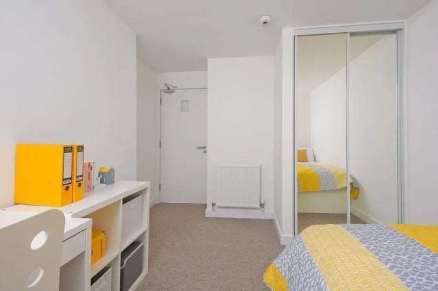 Desk yellow binders and bed with yellow bedding bedroom at King Street 403 in Aberdeen Student Accommodation