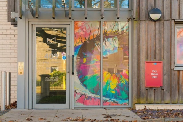 Colorful artwork on entrance glass building exterior at King Street 403 in Aberdeen Student Accommodation