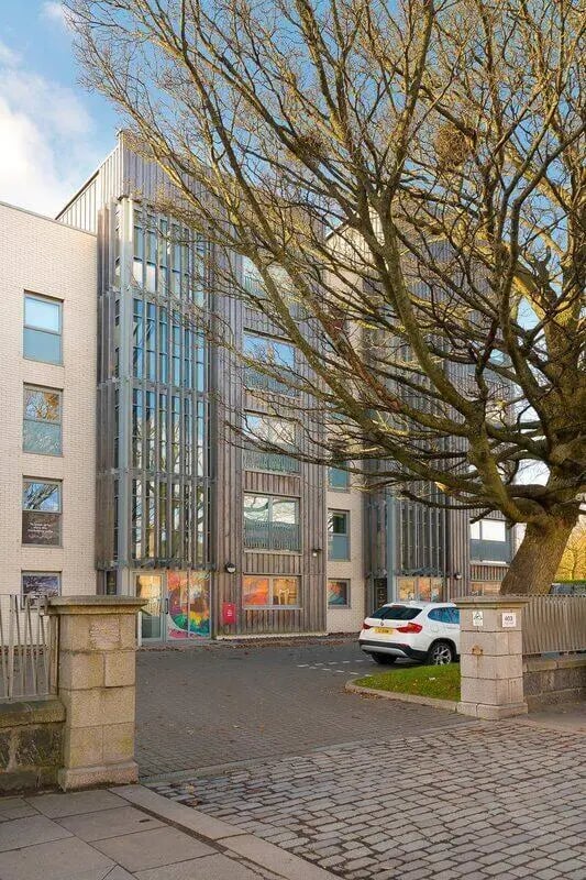 Modern building with white brick and wood panels exterior at King Street 403 in Aberdeen Student Accommodation