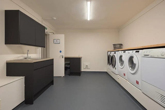 Sink cabinets washing machines laundry room at King Street 207 in Aberdeen Student Accommodation