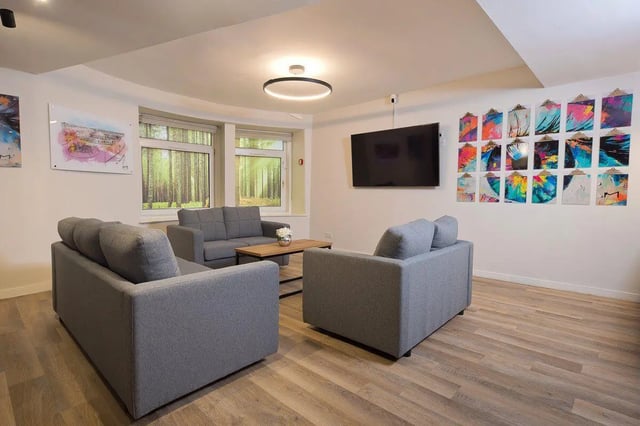 Gray sofas coffee table colorful art living room at King Street 207 in Aberdeen Student Accommodation
