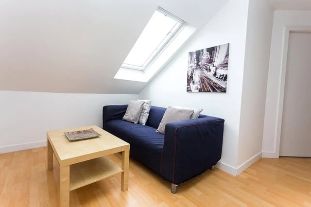Blue sofa with pillows and coffee table living room at King Street 207 in Aberdeen Student Accommodation