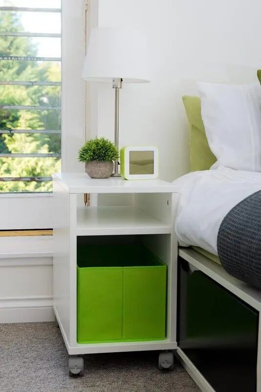 White nightstand with green bin bedroom at Linksfield in Aberdeen Student Accommodation