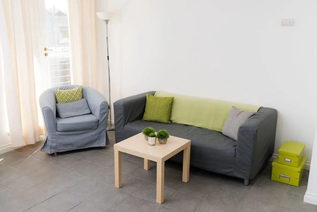 Sofa armchair table plants storage boxes living room at Linksfield in Aberdeen Student Accommodation