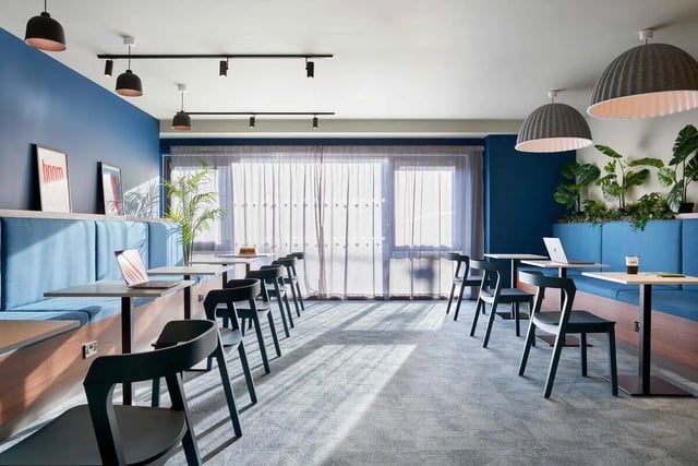 Blue booths and tables with laptops and plants communal area at Edinburgh Westfield in Edinburgh Student Accommodation