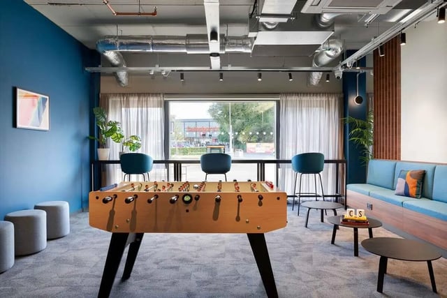 Foosball table blue couch and seating area living room at Edinburgh Westfield in Edinburgh Student Accommodation