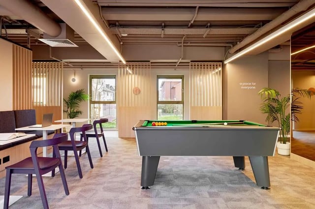 Pool table with purple chairs and laptop living area at Edinburgh Gorgie in Edinburgh Student Accommodation