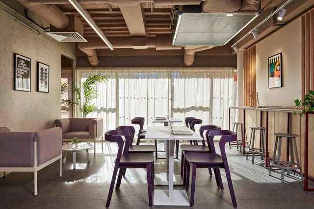 Modern common area with purple chairs and laptops living room at Edinburgh Gorgie in Edinburgh Student Accommodation