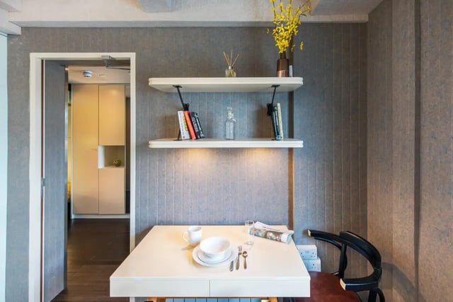 Table with settings books shelves and doorway living area at The Stay Club - Kentish Town in London Student Accommodation