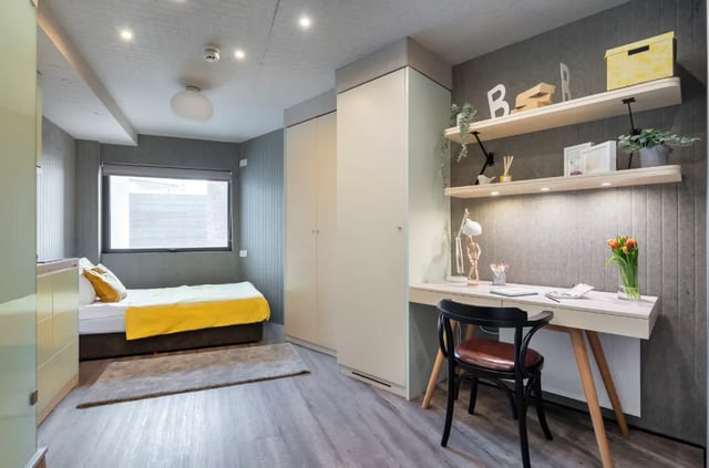 Bed desk and shelves bedroom study area at The Stay Club - Kentish Town in London Student Accommodation