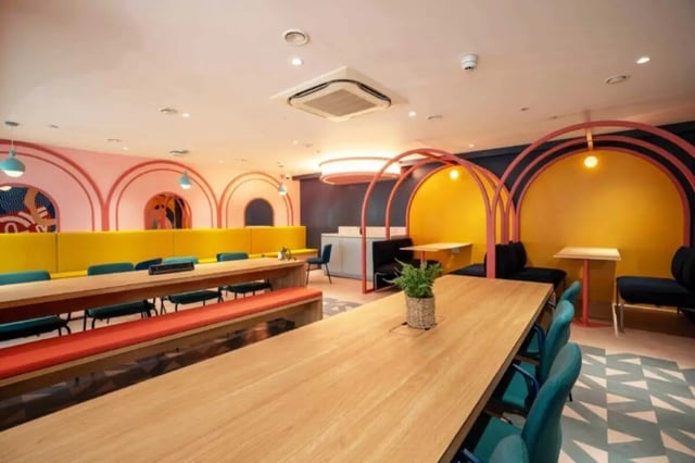 Colorful booths and long tables common area at Oxford Point in Bournemouth Student Accommodation