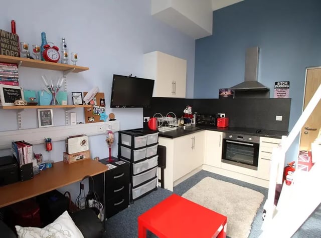 Desk shelves TV kitchen cabinets and oven kitchen at Radmoor House in Loughborough Student Accommodation