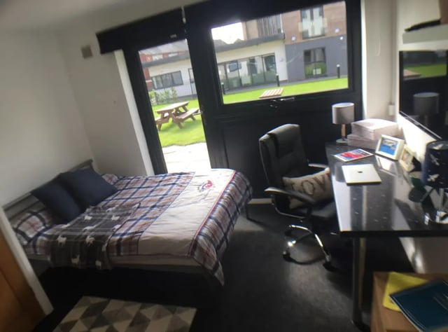Bed desk chair rug bedroom at Forest Court in Loughborough Student Accommodation