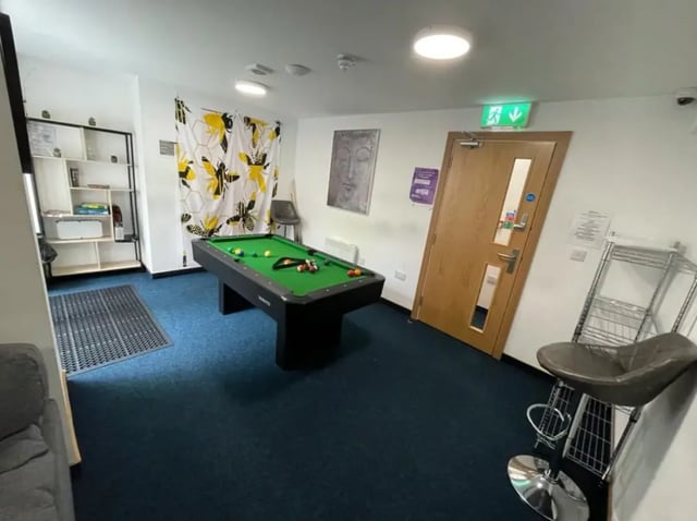 Pool table shelves stool and door Common room at Salisbury Road in Leicester Student Accommodation