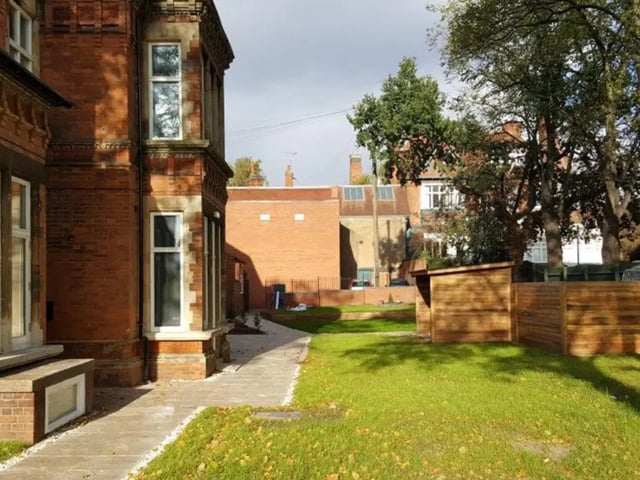 Brick building pathway green grass wooden shed exterior at Regent Road in Leicester Student Accommodation