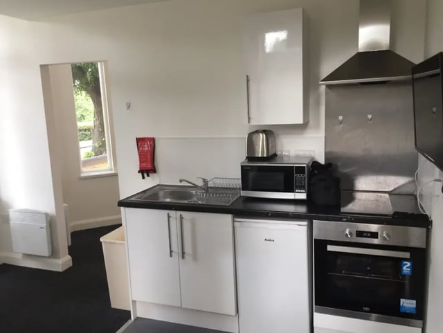 Sink microwave oven toaster cabinets kitchen at Regent Road in Leicester Student Accommodation