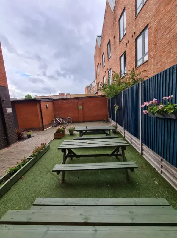 Picnic tables on astroturf outdoor space exterior at The Student Block in Loughborough Student Accommodation