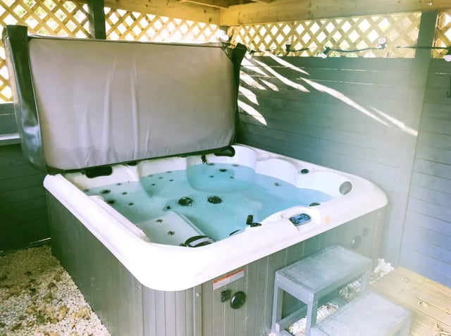 Hot tub with open lid and steps outdoor area at Kingfisher Halls in Loughborough Student Accommodation