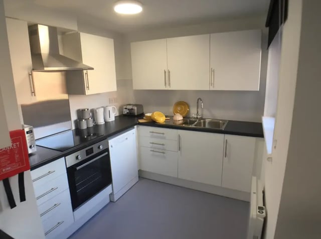 Modern white kitchen with appliances and cabinets kitchen at Kingfisher Halls in Loughborough Student Accommodation