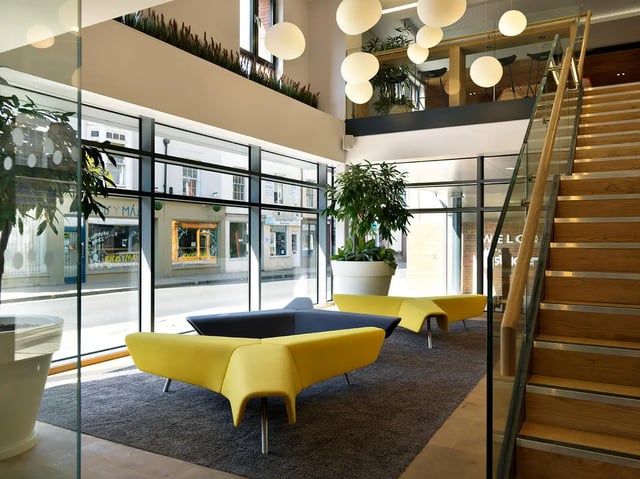 Modern lounge seating with stairs and plant at Student Castle York in York Student Accommodation