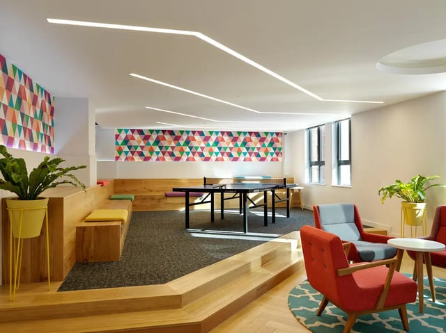 Ping pong table chairs and colourful geometric wall decor common area at Student Castle York in York Student Accommodation