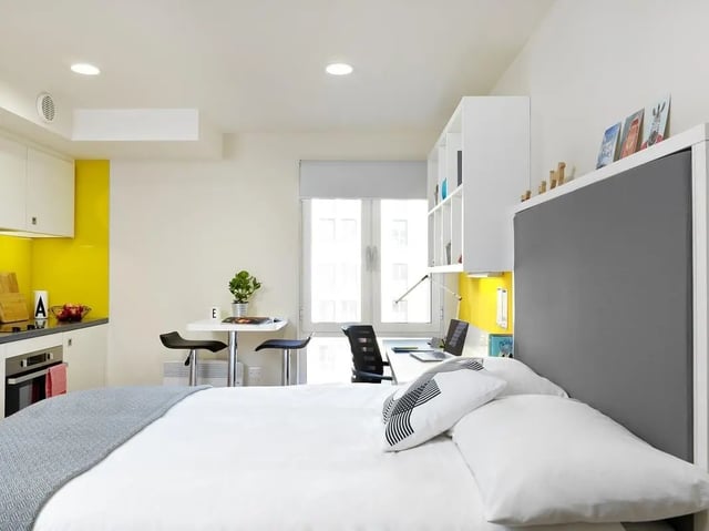 Bed kitchen table desk shelving study area bedroom at Student Castle York in York Student Accommodation