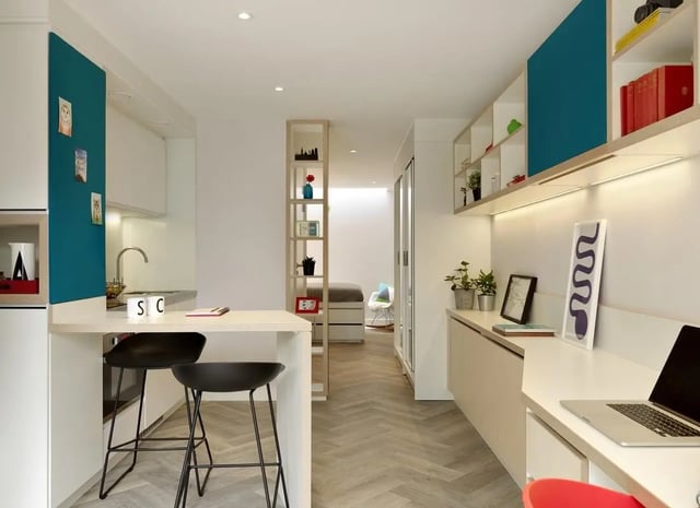 Kitchenette with counter two stools and desk study area at Student Castle Cambridge in Cambridge Student Accommodation
