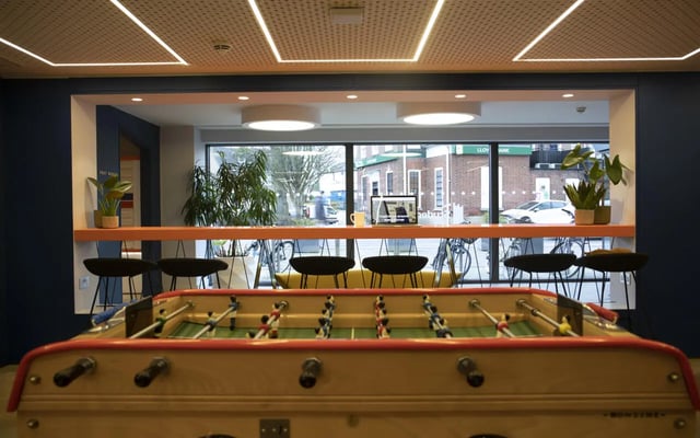 Foosball table bar stools and laptops communal area at Student Castle Cambridge in Cambridge Student Accommodation
