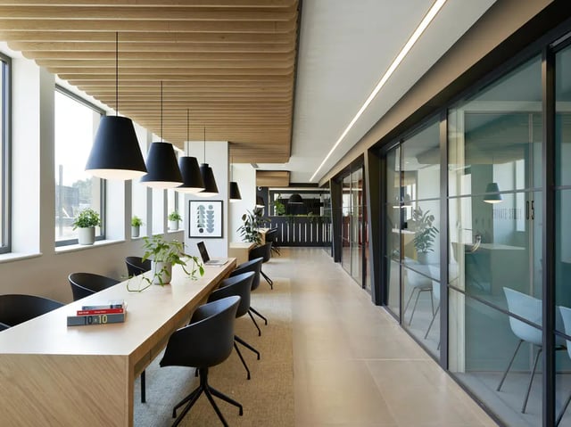 Long wooden table black chairs study area at Student Castle Oxford in Oxford Student Accommodation