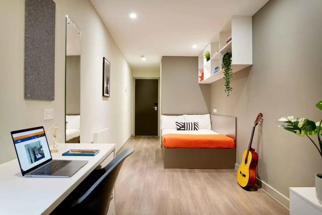Laptop desk bed guitar and plants bedroom at Saw Mill in Huddersfield Student Accommodation