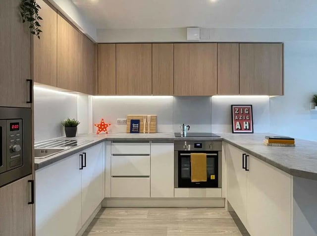 Modern kitchen with built-in appliances and wood cabinets kitchen at Snow Island in Huddersfield Student Accommodation
