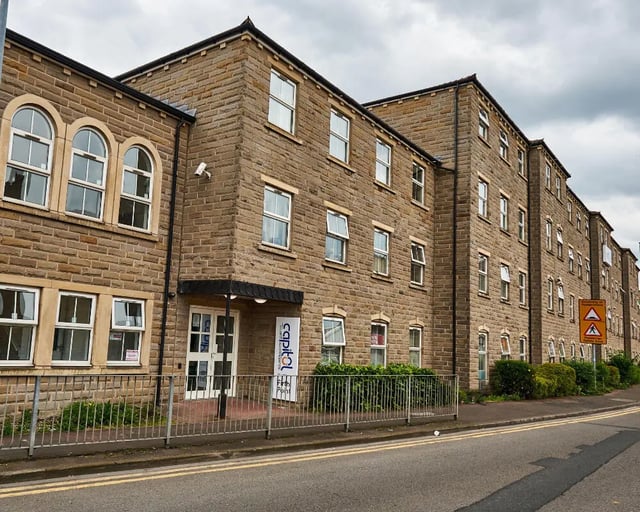 Stone building with arched windows entrance exterior at Firth Point in Huddersfield Student Accommodation