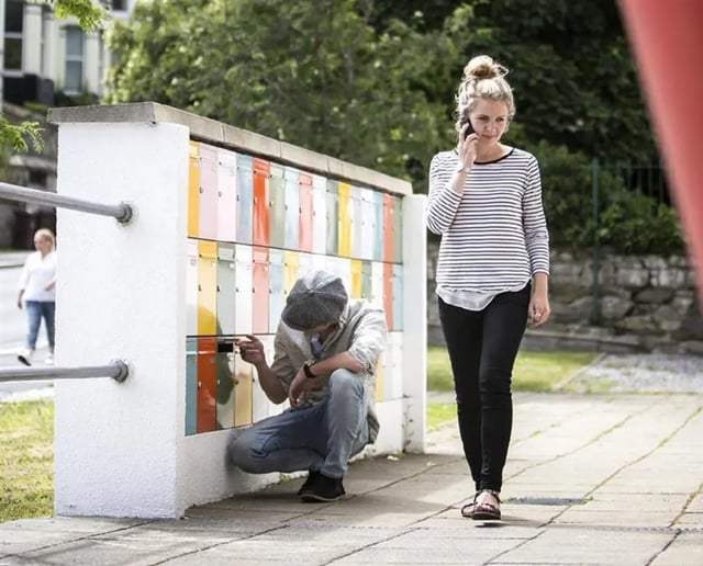 Colorful mailboxes with people outside exterior at Alexandra Works in Plymouth Student Accommodation
