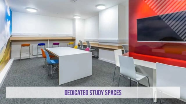 White table colorful chairs modern study space at Kensington House in Birmingham Student Accommodation