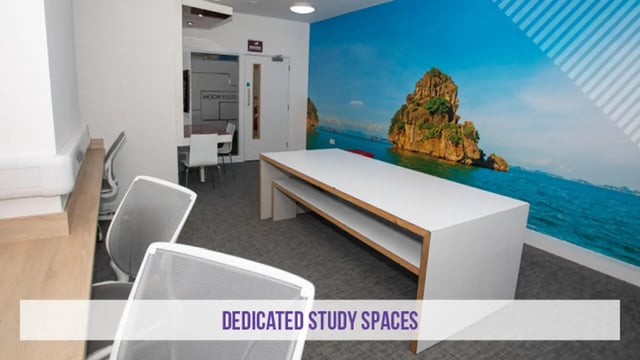 Long white table chairs and mural study area at Kensington House in Birmingham Student Accommodation