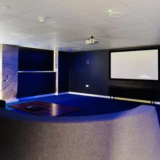Projector screen and modern lounge area living room at The Courtyard Block A in Huddersfield Student Accommodation