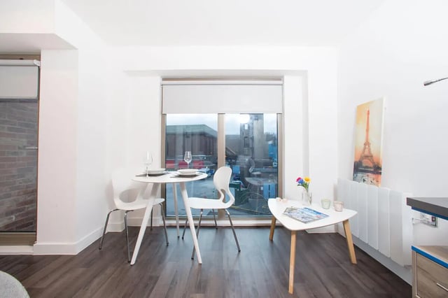 White table chairs and artwork living room at Northgate Point in Chester Student Accommodation