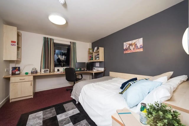 Bed desk chair shelves and artwork bedroom at Aspect 3 Apartments in Sheffield Student Accommodation