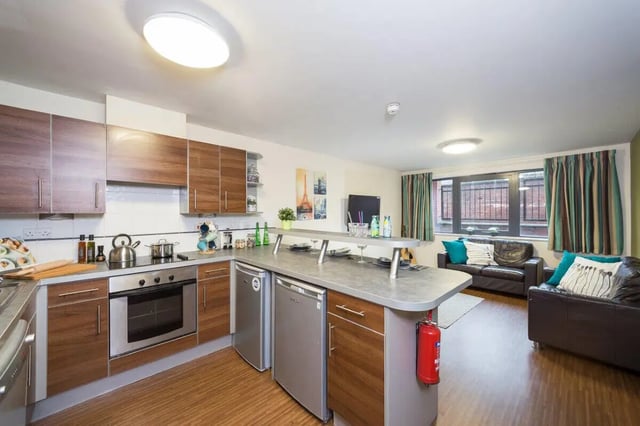 Kitchen with island, sofas, and window Living Room at Aspect 3 Apartments in Sheffield Student Accommodation