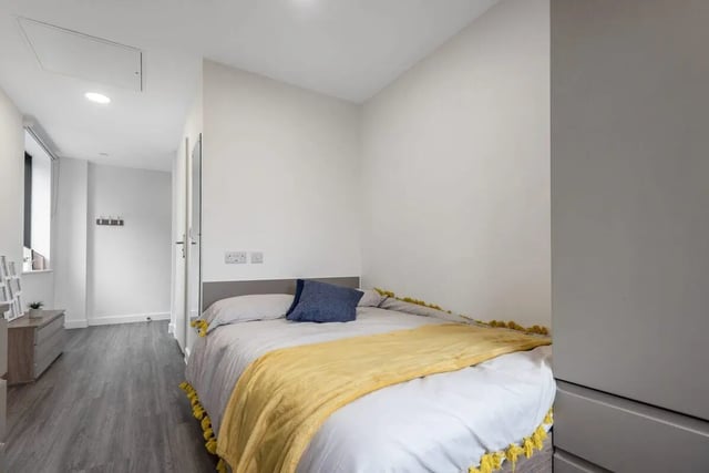 Bed with yellow throw dresser and doorway bedroom at Stanhope House Portsmouth in Portsmouth Student Accommodation