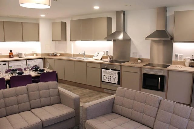 Sofas washing machines dining table kitchen living area at Coppergate Swansea in Swansea Student Accommodation