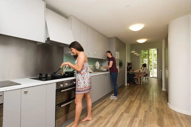 Women cooking in modern kitchen with dining area kitchen at Graystacks in Nottingham Student Accommodation