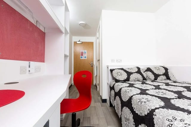 Desk bed red chair door bedroom at Abbey House in Coventry Student Accommodation